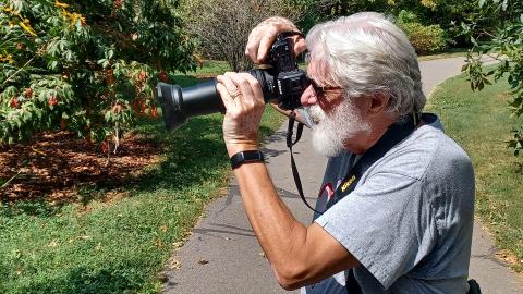 Docent Craig Sargent takes a photo